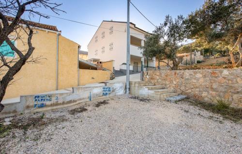 a house with blue graffiti on the side of it at Holiday Home Ruby in Sveti Jakov