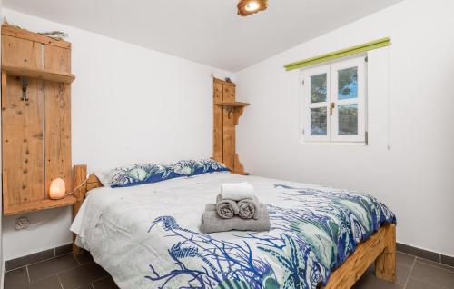 a bedroom with a bed with a towel on it at Holiday Home Ruby in Sveti Jakov