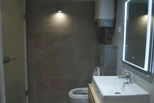 a bathroom with a sink and a toilet at Old stone house in historical area in Split
