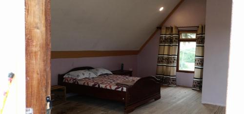 a small bedroom with a bed in a attic at Bagamoyo Home Stay in Bagamoyo