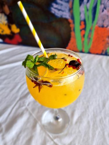 a drink with a straw in a glass on a table at Pousada Seven in Arraial do Cabo