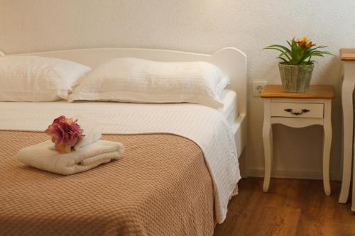 a bedroom with a bed with a towel on it at Old stone house in historical area in Split