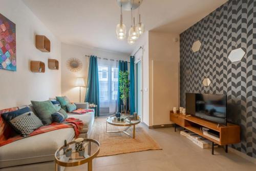 een woonkamer met een bank en een tv bij Apartment with terrace and garage Classified 4 stars in Annecy