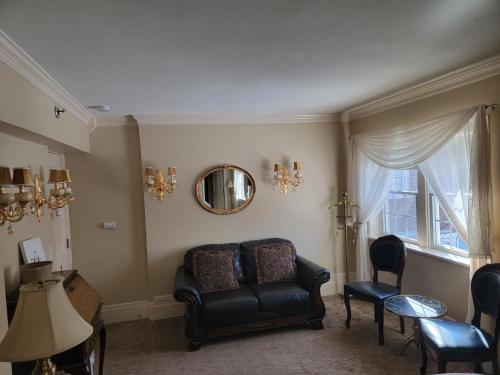 a living room with a couch and a table and a mirror at Lowell Inn in Stillwater