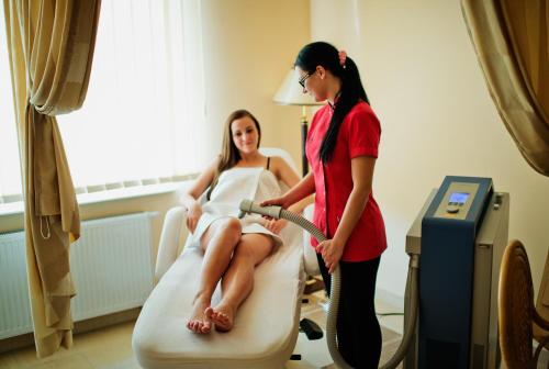 a woman is fuelling a woman in a hospital room at Royal Park Hotel & Spa in Mielno