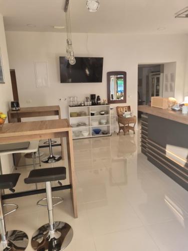 a kitchen with a table and a counter top at Hostel Jadran in Pag