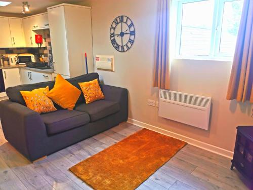 a living room with a couch and a window at Sunflower Apartment, Family accommodation Near Tenby in Pembrokeshire in Tenby