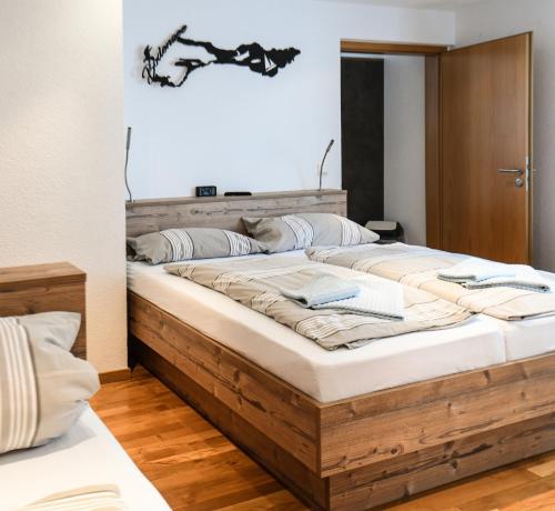 a bedroom with a large wooden bed in a room at Gasthof Rebstock in Friedrichshafen