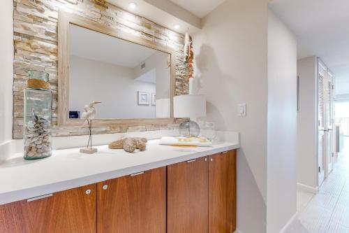 a bathroom with a sink and a mirror at Ocean Vista #1004 in South Padre Island