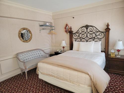 a hotel room with a bed and a chair at Lowell Inn in Stillwater
