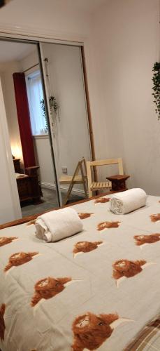 a bedroom with a bed with brown dog prints on it at Taigh Na Frithe in Fort Augustus