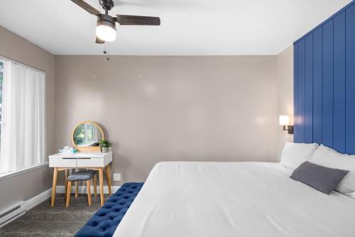 a bedroom with a large white bed and a desk at The Inn at Boatworks, Lake Tahoe in Tahoe City