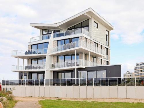 a tall white building with balconies on it at 8 person holiday home in Wendtorf in Wendtorf