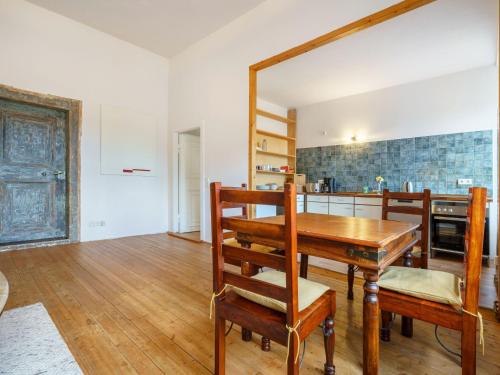 a kitchen and dining room with a table and a mirror at Apartment in Gerbstedt Friedeburg with Terrace in Friedeburg