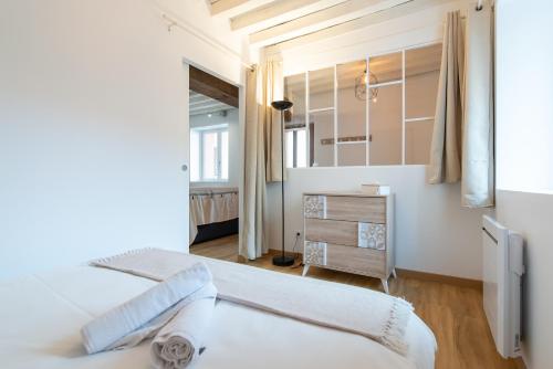 a bedroom with two beds and a mirror at Ambiance bohème in Roanne