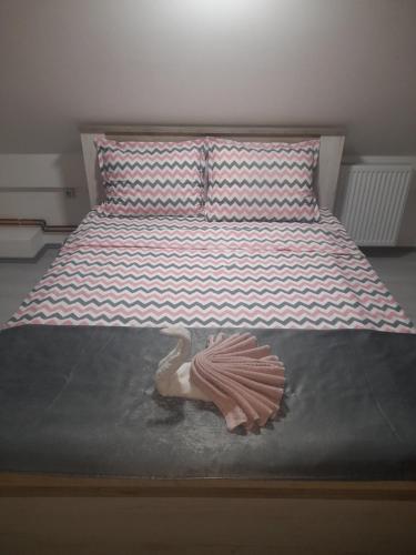 a bedroom with a bed with a dummy on it at Family Apartmani Le in Leskovac