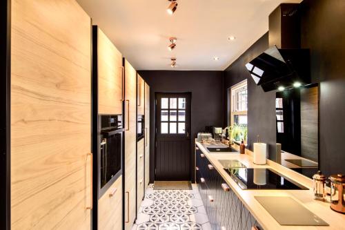 a kitchen with black walls and a counter top at Sea Retreats, Whitley Bay, Sleeps 8 in Whitley Bay