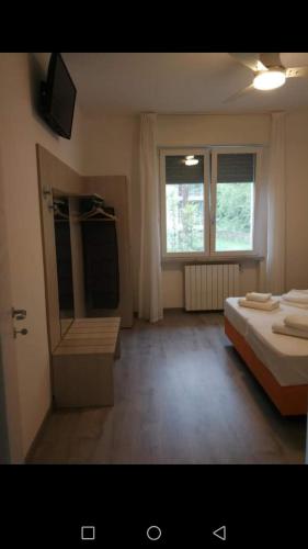 a bedroom with a bed and a sink and a window at La Svolta Holidays in Malcesine