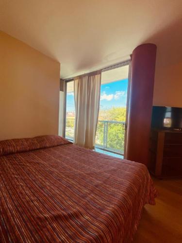 a hotel room with a bed and a large window at Hotel Sierra Inn in Xicotepec de Juárez