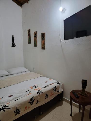 a bedroom with a bed and a flat screen tv at Rosita 2 in Jardin
