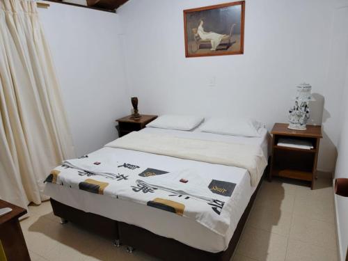 a bedroom with a bed with a blanket on it at Rosita 2 in Jardin