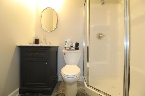 a bathroom with a shower and a toilet and a sink at Modern Tiny House Experience in Stone Mountain