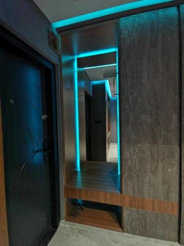a mirror in a room with blue lights at PentLux - SPA Penthouse in the heart of Skopje in Skopje
