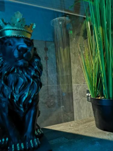 a statue of a lion wearing a crown next to a plant at PentLux - SPA Penthouse in the heart of Skopje in Skopje