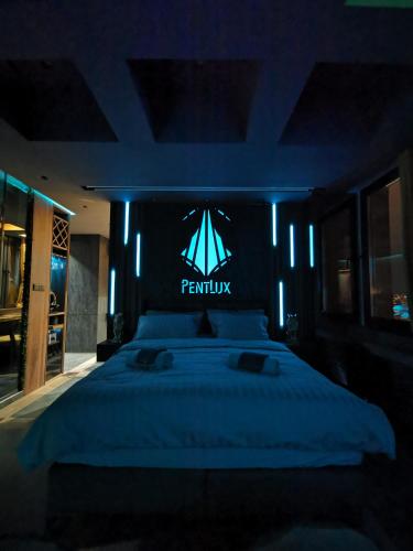 a bedroom with a large bed with a pymyu sign on it at PentLux - SPA Penthouse in the heart of Skopje in Skopje