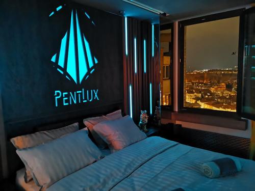 a bedroom with a bed with a sign on the wall at PentLux - SPA Penthouse in the heart of Skopje in Skopje