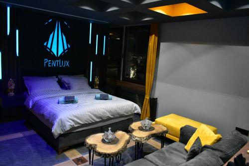 a bedroom with a bed and two tables and a couch at PentLux - SPA Penthouse in the heart of Skopje in Skopje
