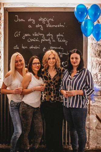 a group of women standing in front of a chalkboard at Apartments Rose Garden in Děčín