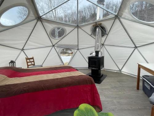 a bedroom with a bed in a dome tent at Laurel River Club Bed & Breakfast or LRCBNB in Dryfork