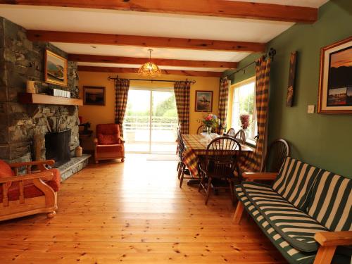 a living room with a table and a fireplace at The Lodge in Beaufort