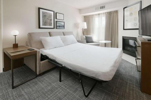 a hotel room with a large bed and a couch at Sonesta ES Suites Fort Worth Fossil Creek in Fort Worth