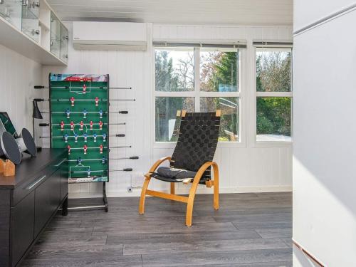a chair in a room with a desk and window at 7 person holiday home in Ulfborg-By Traum in Ulfborg