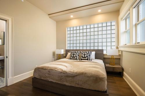 a bedroom with a bed and a large window at The Edward Buffalo in Buffalo