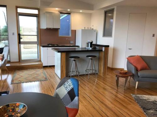 a kitchen and living room with a table and a counter at Wedgetaildown in Parndana