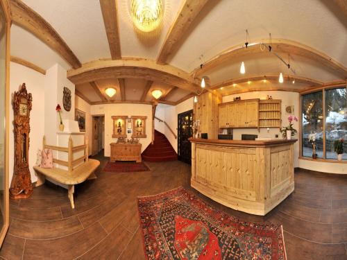 a large room with a kitchen and a living room at Christeinerhof in Santa Cristina in Val Gardena