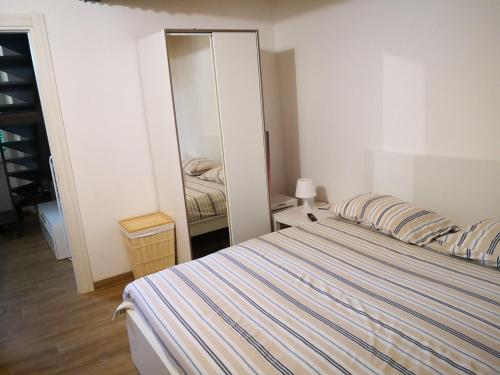a bedroom with a bed and a mirror at FLATS 15 - New Opening in Rome