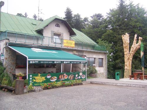 a building with a food stand in front of it at Penzion Čertovy Kameny in Jeseník