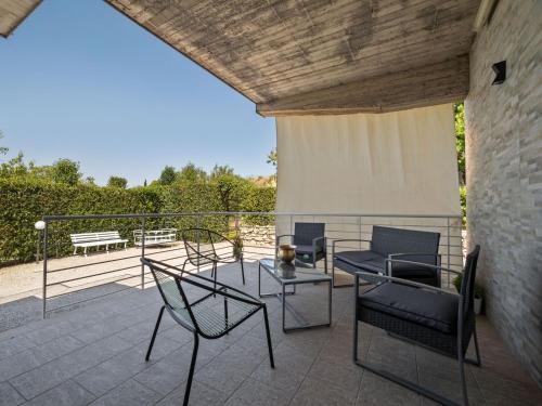 a patio with chairs and a table and a couch at Belvilla by OYO Modern villa in Nissoria with pool in Nissoria
