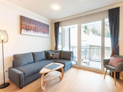 a living room with a couch and a table at Holiday apartment in Zwieselstein near S lden in Sölden