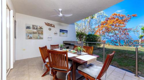 a dining room with a table and chairs at The Summit - Trinity Beach - Ocean Views !! in Trinity Beach