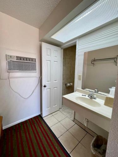a bathroom with a sink and a mirror at Red River Inn in Clarksville