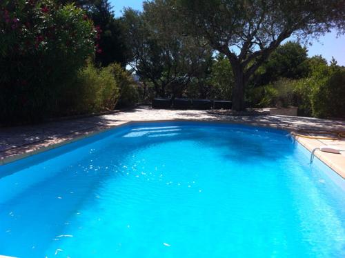 a large blue swimming pool in a yard at Luxueuse Villa - Golfe de St Tropez in Sainte-Maxime