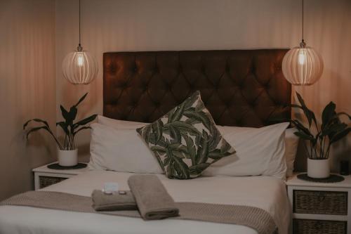a bed with two potted plants on top of it at Villa Rose Guesthouse & Venue in Bloemfontein