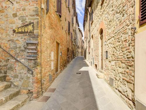 an alley in an old town with stone buildings at Holiday home in Tuscany with shared pool in Querce