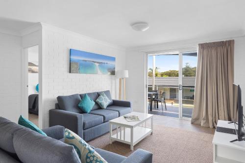 a living room with a couch and a table at Seaside Holiday Resort in Fingal Bay
