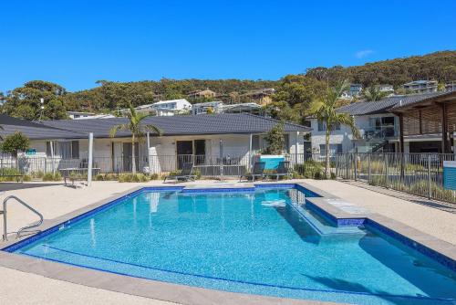 a large swimming pool in a backyard at Seaside Holiday Resort in Fingal Bay